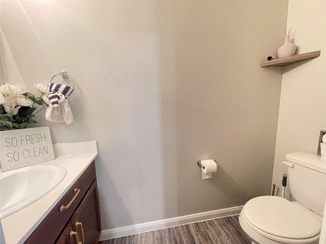 bathroom featuring hardwood / wood-style flooring, vanity, and toilet