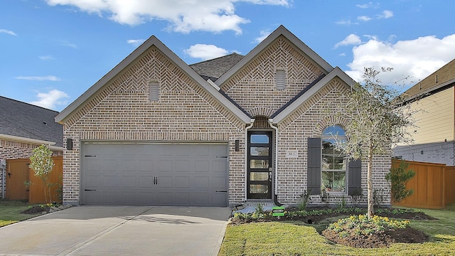 view of front of home with a garage and a front lawn