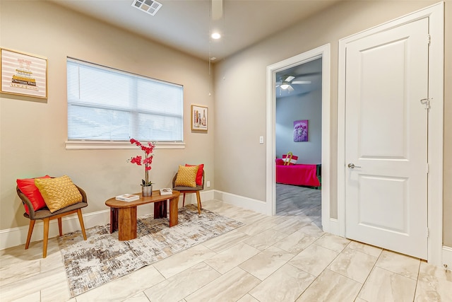 living area with ceiling fan