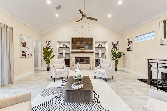 living room featuring a premium fireplace, ceiling fan, built in shelves, and ornamental molding