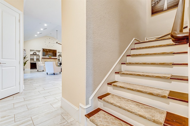 stairs with hardwood / wood-style floors and vaulted ceiling