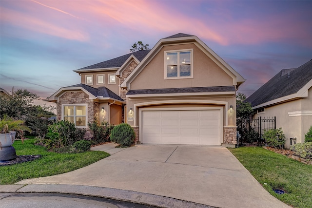 view of front of home featuring a garage and a lawn