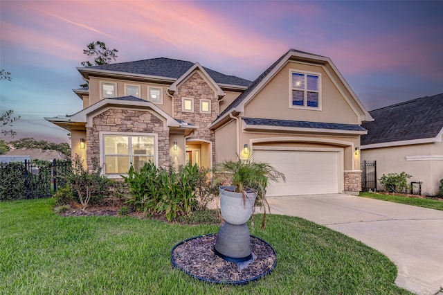 view of front of property with a garage and a yard