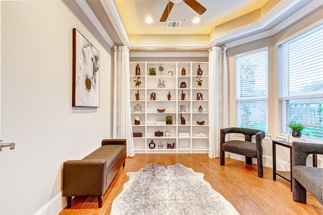 sitting room featuring wood-type flooring and ceiling fan