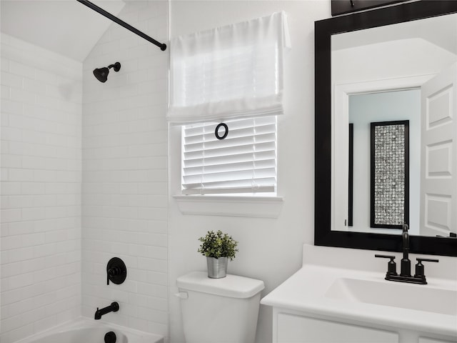 full bathroom featuring toilet, vanity, lofted ceiling, and tiled shower / bath