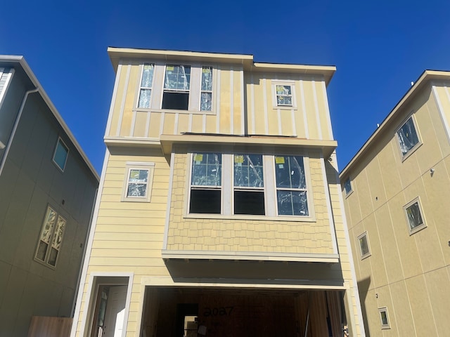 back of house with a garage