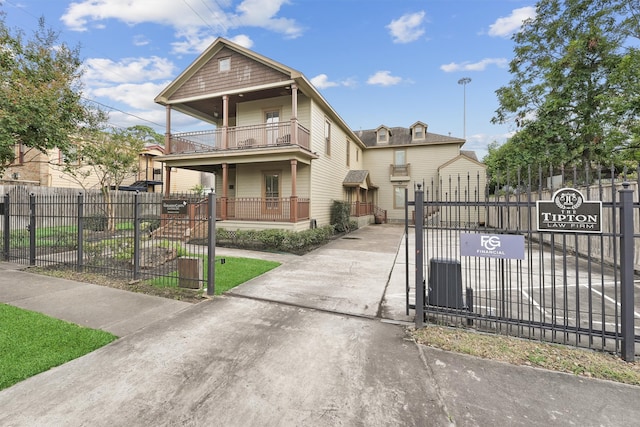 view of front of property featuring a porch and a balcony