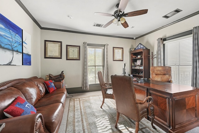 carpeted home office featuring ceiling fan and crown molding