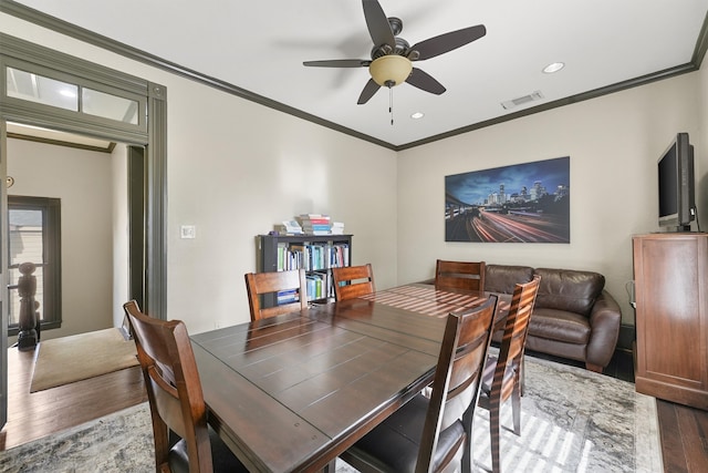 dining room featuring hardwood / wood-style floors, ceiling fan, and ornamental molding