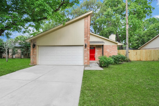 view of front of property featuring a garage and a front lawn