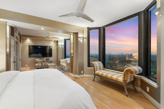 bedroom with ceiling fan and light hardwood / wood-style flooring