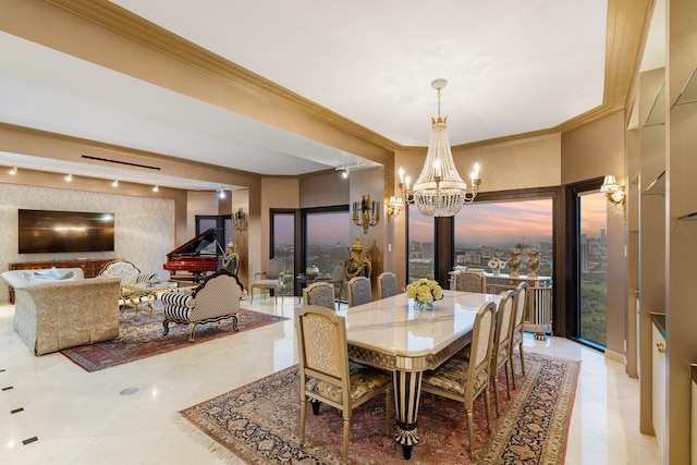 dining room with crown molding, rail lighting, and a notable chandelier