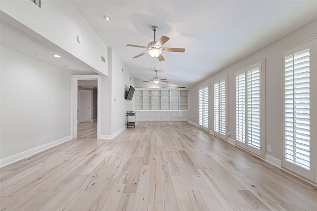 unfurnished living room featuring visible vents, baseboards, a ceiling fan, light wood-style flooring, and vaulted ceiling