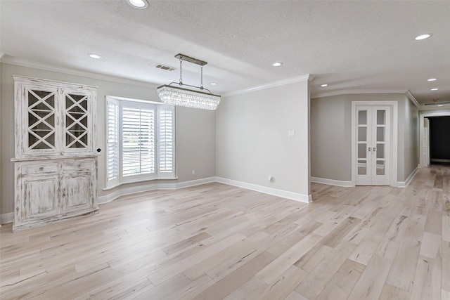 unfurnished dining area featuring visible vents, light wood-style flooring, and crown molding