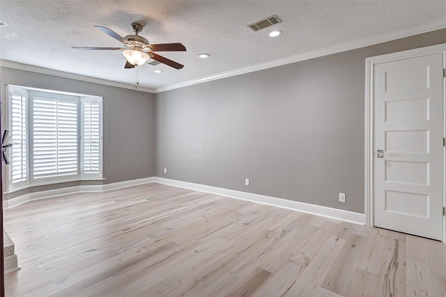 unfurnished room with crown molding, light wood finished floors, visible vents, ceiling fan, and baseboards