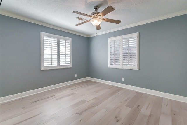 spare room with baseboards, visible vents, wood finished floors, crown molding, and a textured ceiling