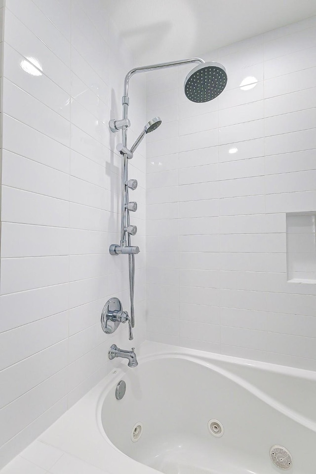 bathroom with a combined bath / shower with jetted tub