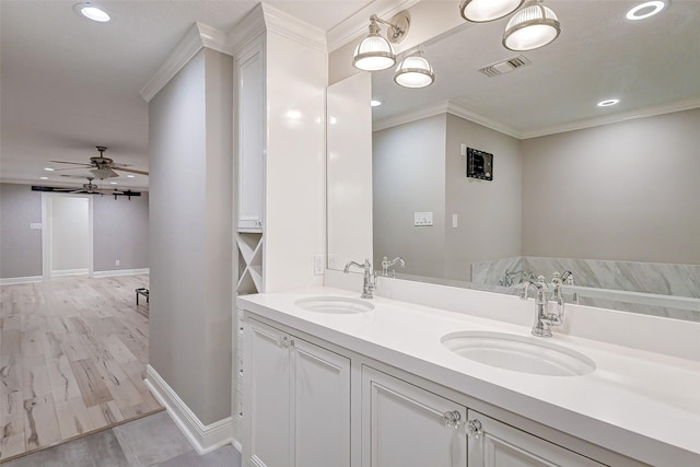 full bath featuring double vanity, visible vents, a sink, and ornamental molding