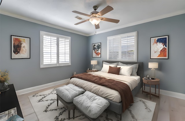 bedroom with light wood finished floors, baseboards, visible vents, a ceiling fan, and crown molding