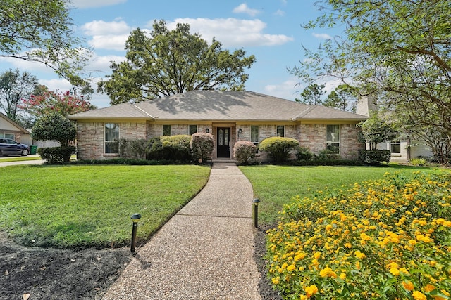 single story home featuring a front yard