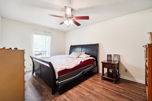 bedroom with a textured ceiling, dark wood-type flooring, and ceiling fan