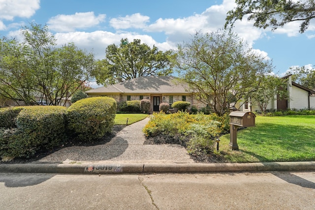 ranch-style house with a front lawn