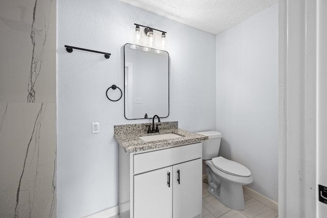 bathroom featuring tile patterned flooring, vanity, a textured ceiling, and toilet