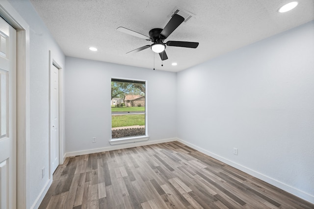 unfurnished bedroom featuring a textured ceiling, light hardwood / wood-style floors, and ceiling fan