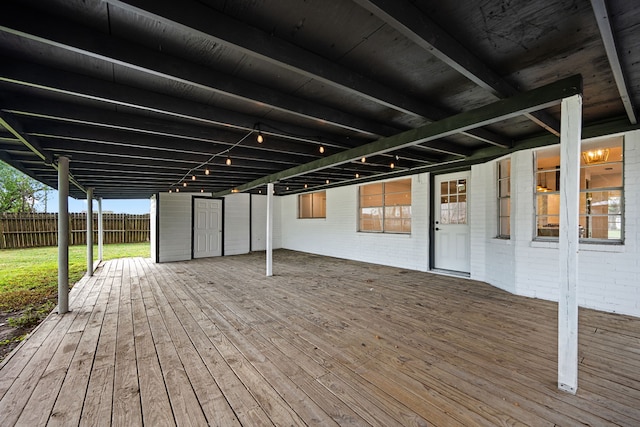 wooden deck featuring a storage unit