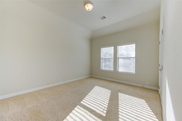 spare room featuring light colored carpet