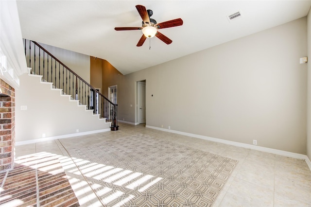 unfurnished living room with ceiling fan, a fireplace, and light tile patterned flooring