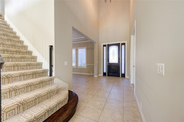 foyer with a high ceiling and light tile patterned flooring