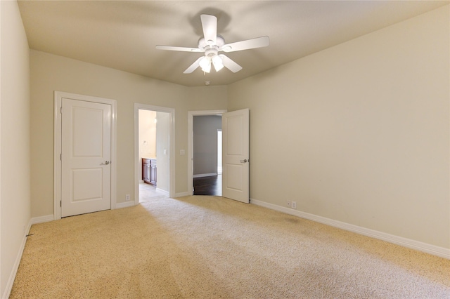 unfurnished bedroom featuring ceiling fan and light colored carpet