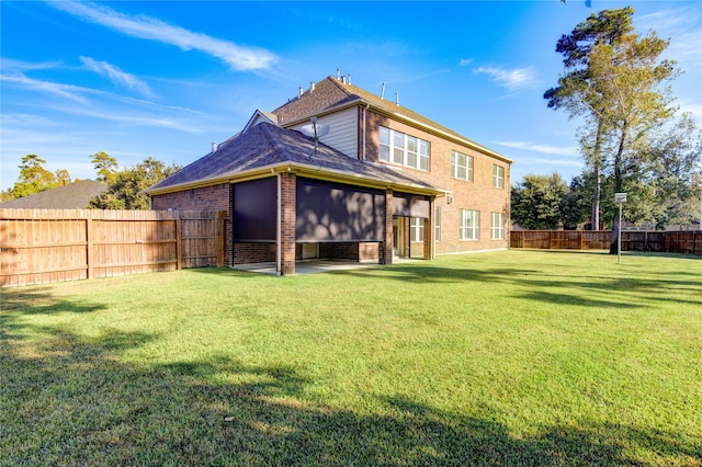 back of property featuring a lawn