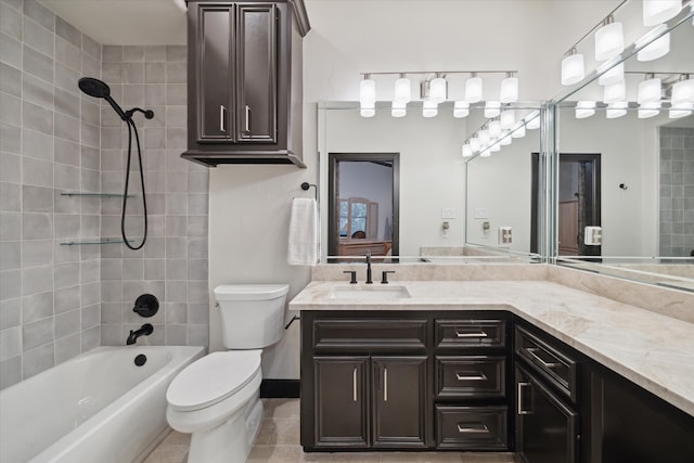 full bathroom with toilet, vanity, tiled shower / bath, and tile patterned floors