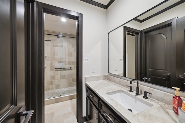 bathroom featuring vanity, an enclosed shower, and ornamental molding