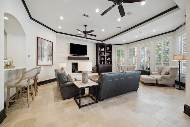 living room featuring ceiling fan and ornamental molding