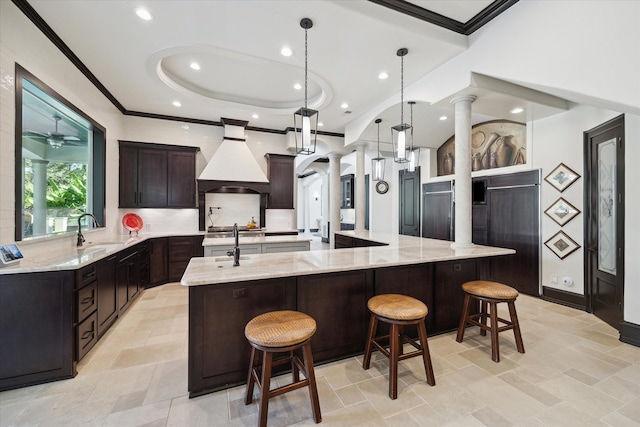 kitchen featuring a spacious island, a kitchen breakfast bar, and decorative light fixtures