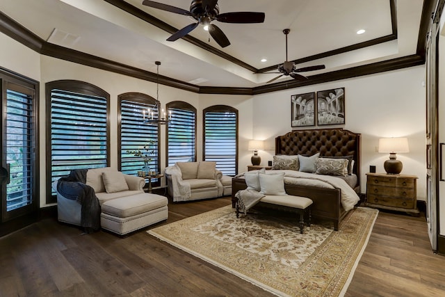 bedroom featuring dark wood-type flooring, ceiling fan with notable chandelier, a raised ceiling, and ornamental molding