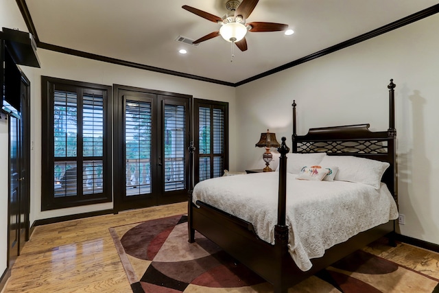 bedroom with light hardwood / wood-style floors, ceiling fan, and crown molding