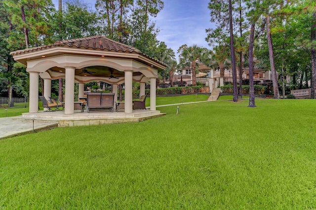 view of home's community with a lawn and a gazebo