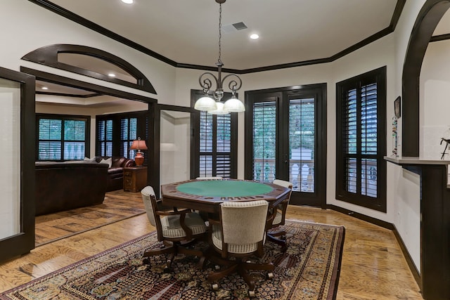 playroom featuring ornamental molding, french doors, a notable chandelier, and light hardwood / wood-style floors