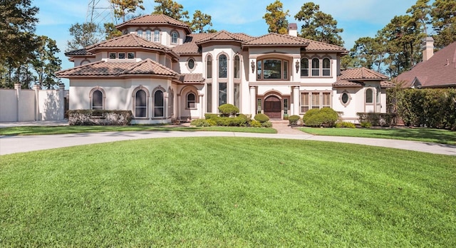 mediterranean / spanish-style house featuring a front yard