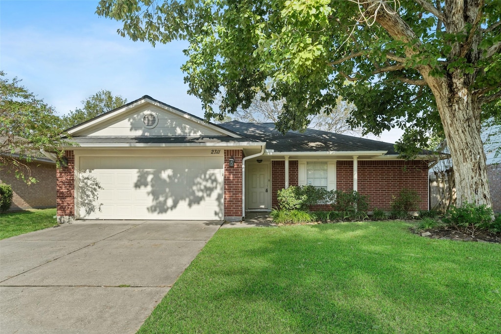 ranch-style home featuring a front lawn and a garage