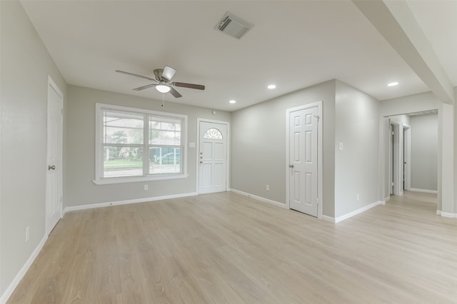 unfurnished living room with light wood-type flooring and ceiling fan