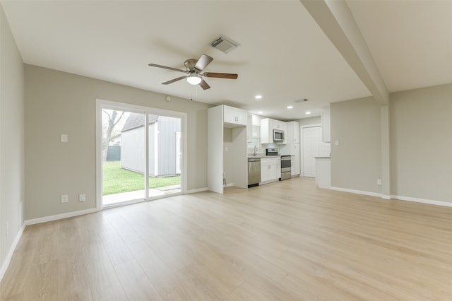 unfurnished living room featuring ceiling fan and light hardwood / wood-style flooring