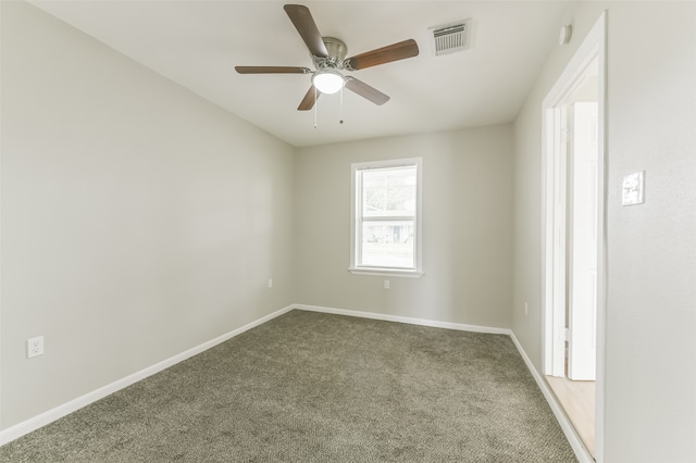 empty room featuring carpet flooring and ceiling fan