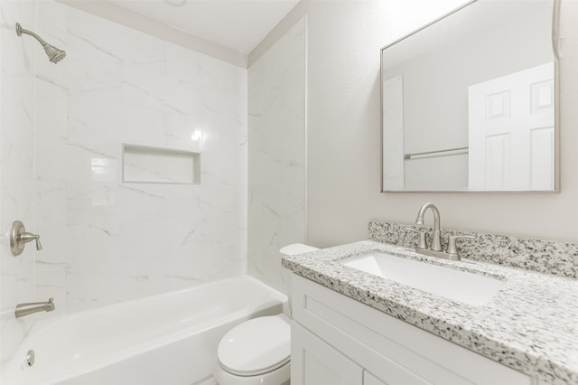 full bathroom with vanity, tiled shower / bath combo, and toilet