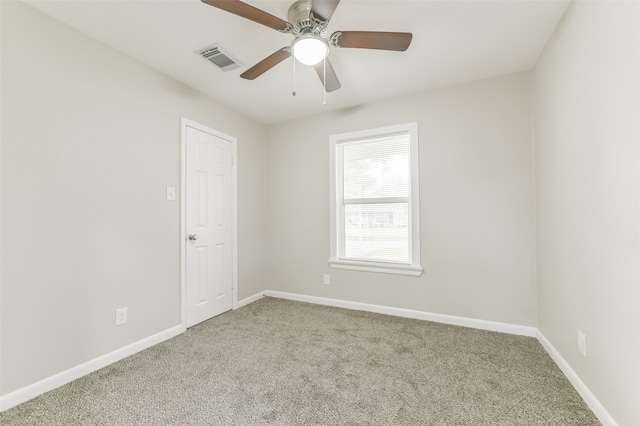 carpeted spare room with ceiling fan