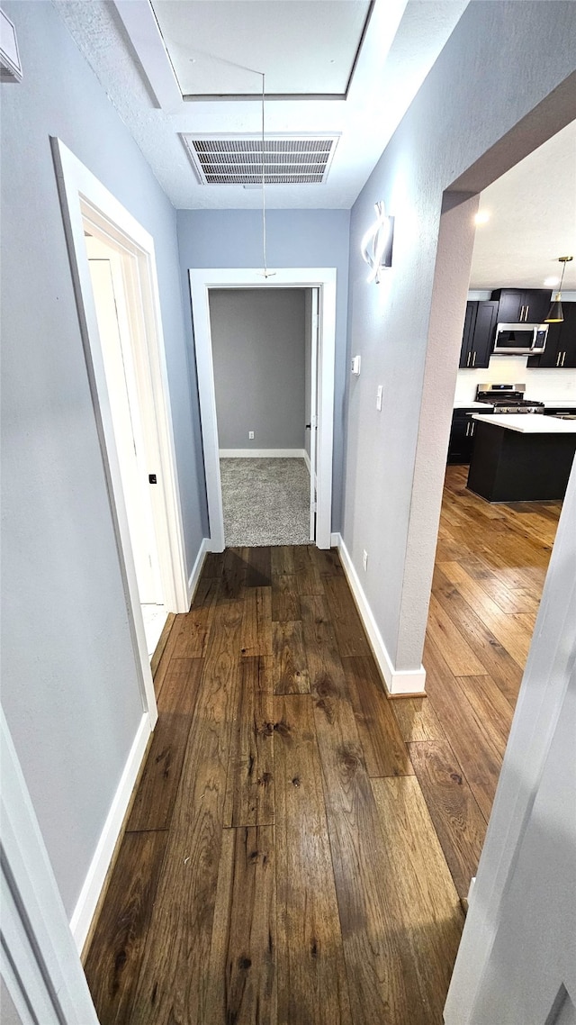 hallway featuring dark hardwood / wood-style flooring